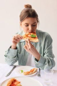 Enjoying a Slice of Pizza