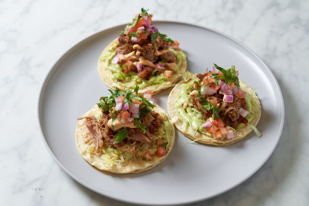 Savory carnitas tacos prepared fresh at Cilantro 27 in Miami Beach, FL.