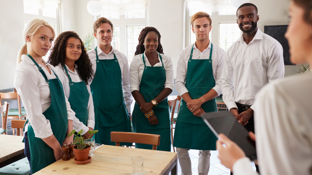 Manager Discussing 2025 Minimum Wage Hikes for Restaurants