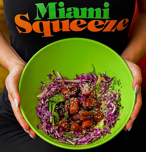 Teriyaki Fish Salad made with teriyaki snapper, lettuce, spinach, red cabbage, and topped with sesame seeds.