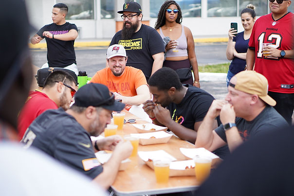 A group of people tailgating 
